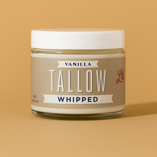 Jar of vanilla tallow whipped product on a beige background