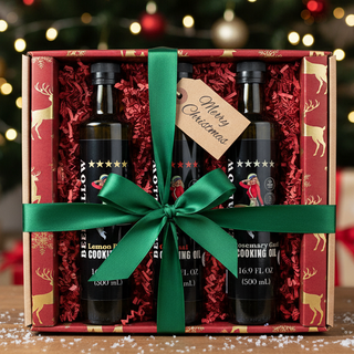 Gift set with two bottles of gin in a decorative box with a green ribbon, Christmas tree in the background.