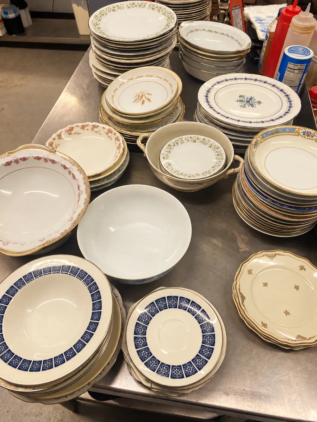 Stacks of mismatched heirloom china prepared for service in the Lady May kitchen