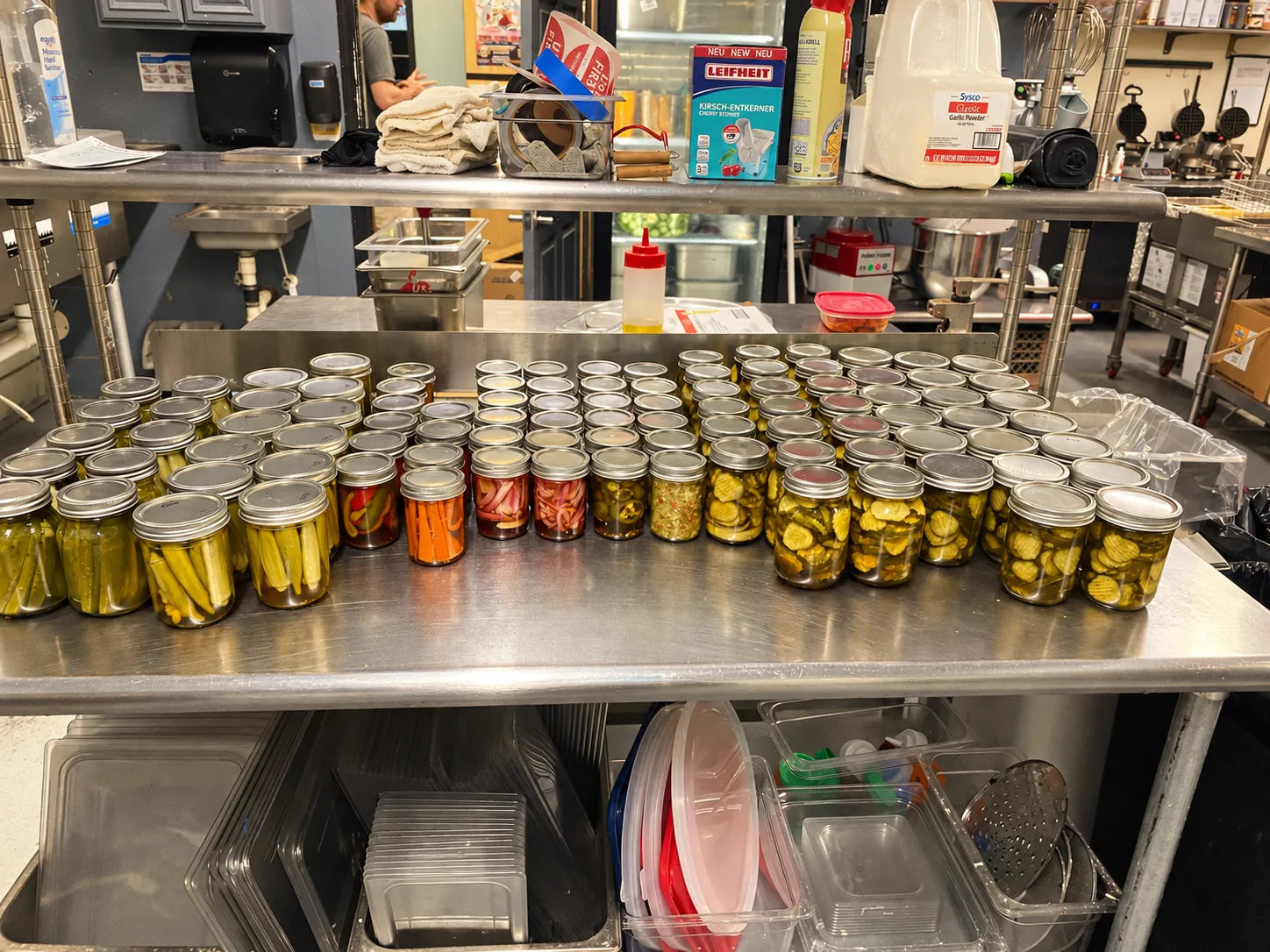 Rows of small-batch pickled vegetables prepared in the Lady May restaurant kitchen